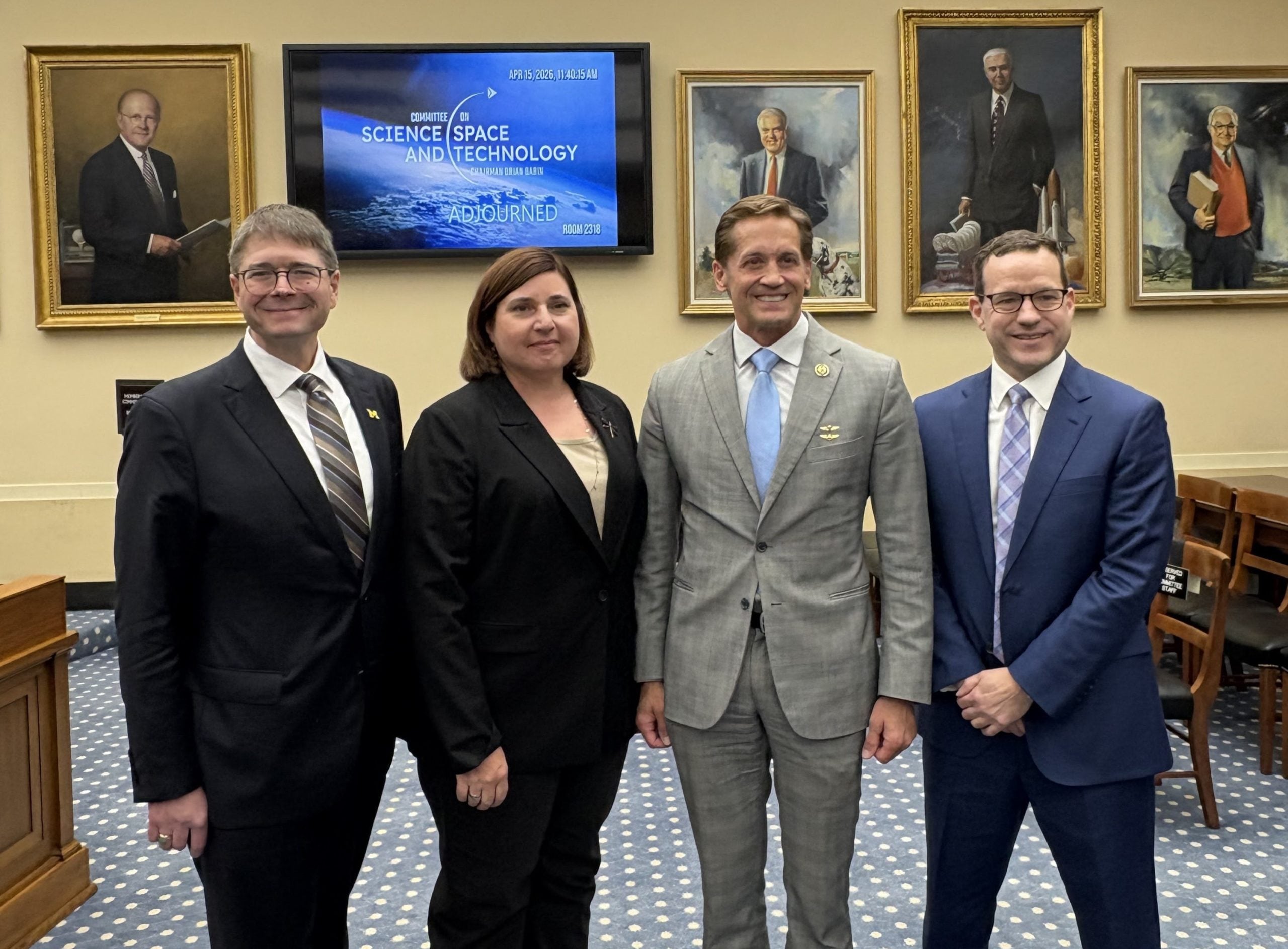 Dr. Jason Owen-Smith, Ms. Kate Travis, Chairman Rich McCormick, and Mr. Carl Maxwell standing in the committee chambers.